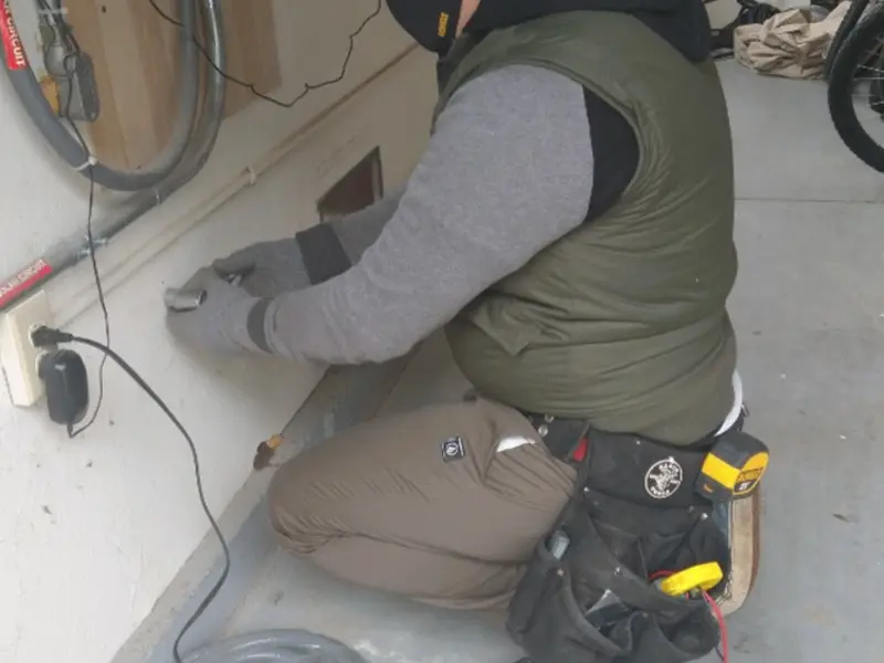 Electrician performing outlet wiring in a Lower Merion garage